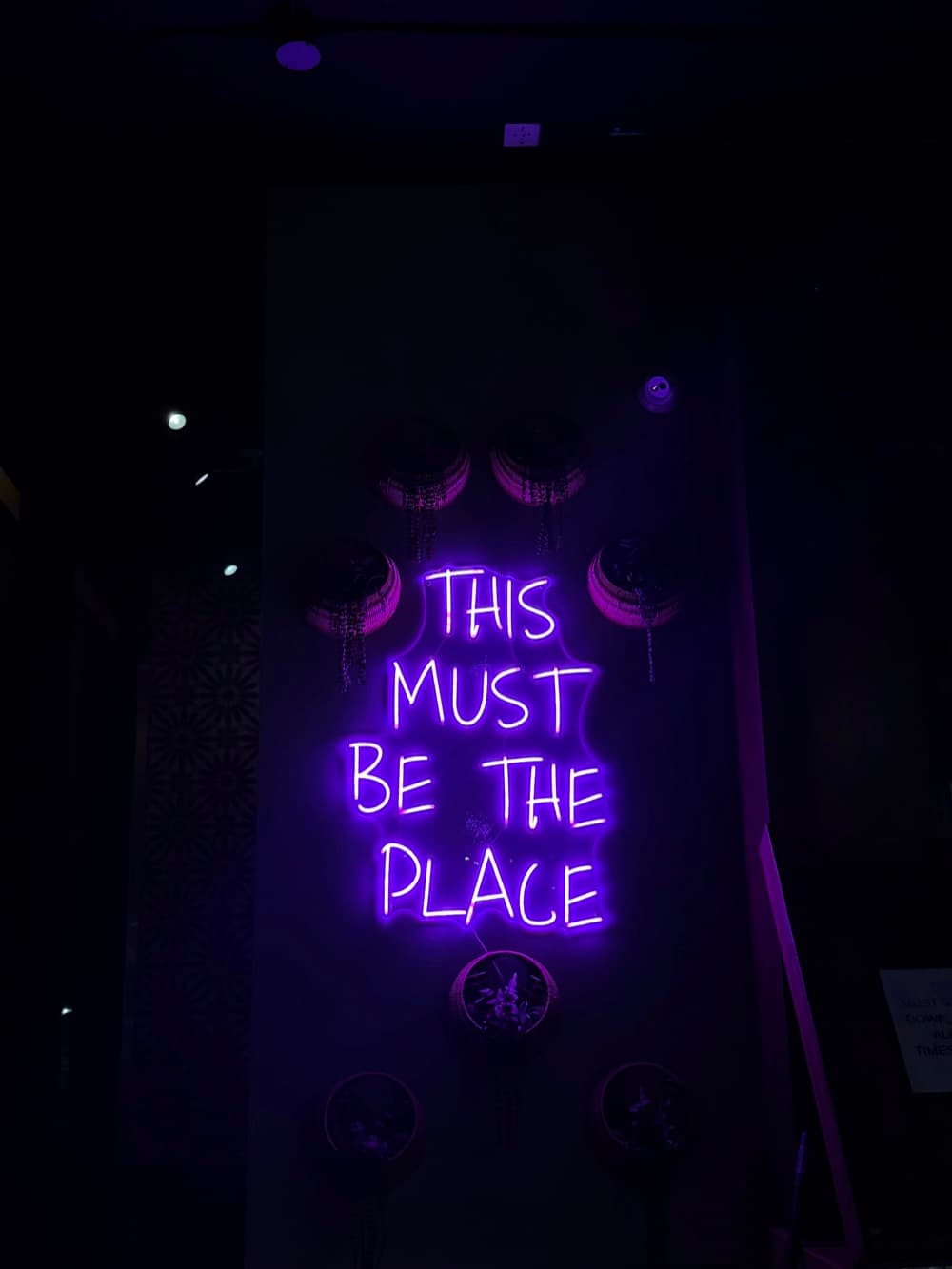 Aura Kitchen and Bar storefront at night
